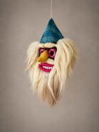 Handmade Romanian Mask with a blue hat, pink eyes, and yellow beak on a brown background