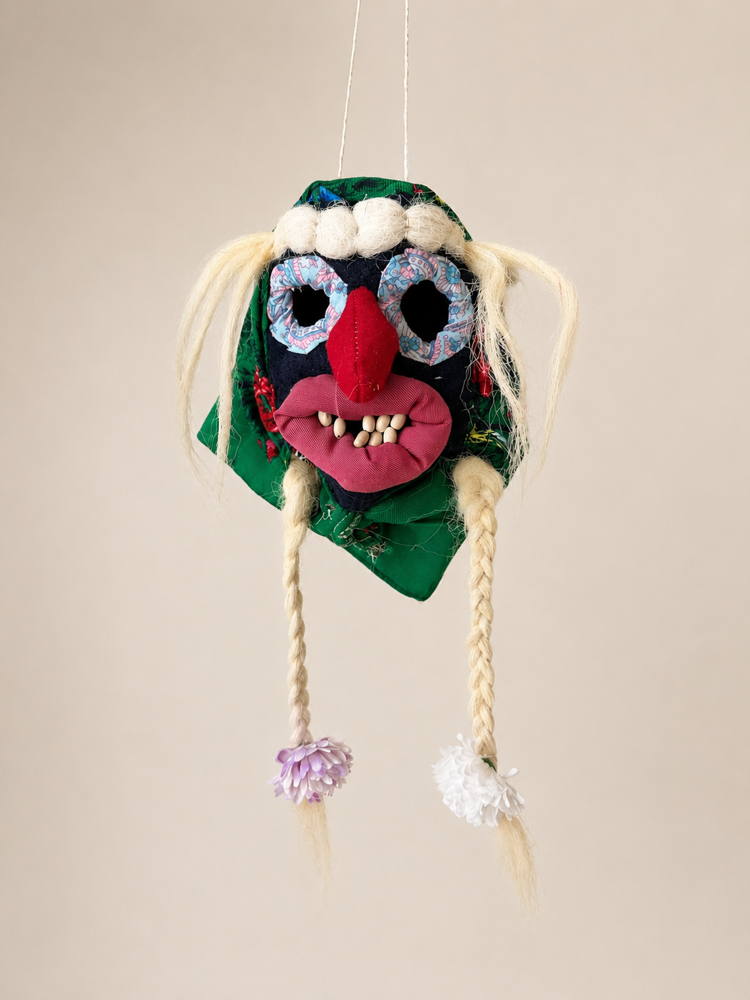 Handmade Romanian Mini Mask Baba Folk with braided hair on a beige background