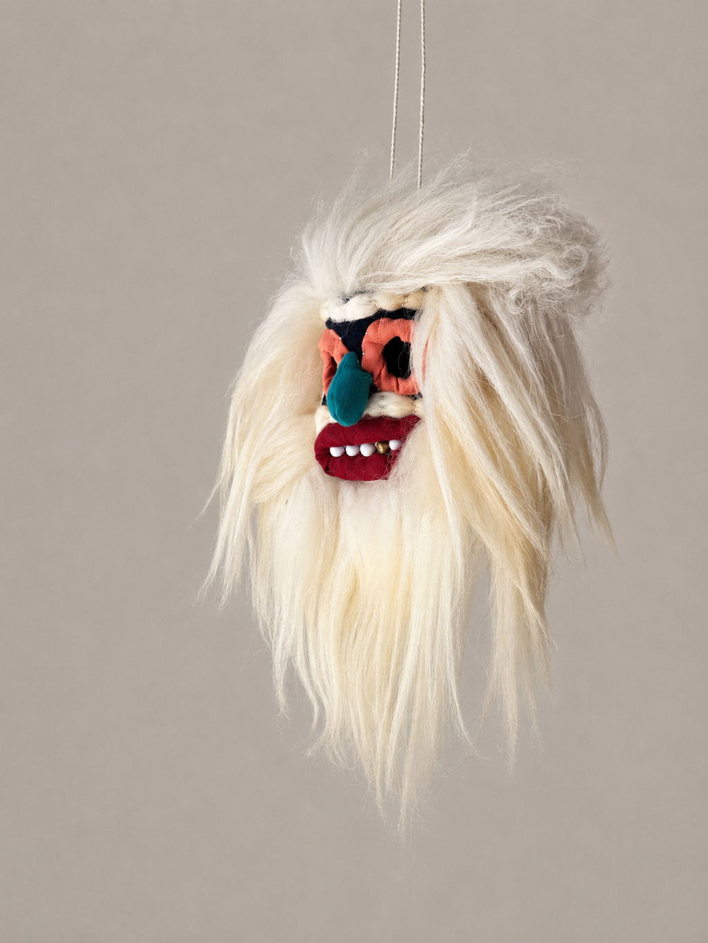 Mini handmade Romanian Moșneag folk mask depicting an elderly village man, decorated with traditional details and expressive features
