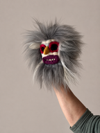 Mini Traditional Romanian Mask with a colorful face held by a person against a neutral background