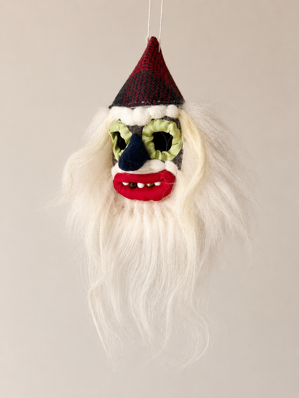 Handmade Romanian Mini Mask Mosneag Folk with a beard, hat, and colorful face on a neutral background